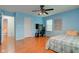 Bright bedroom with wood floors, ceiling fan, desk, and a view to another bedroom at 20107 Marie Ct, Noblesville, IN 46062
