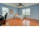 Bedroom with wood floor, a ceiling fan, two windows, and light blue walls at 20107 Marie Ct, Noblesville, IN 46062