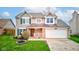 Exterior view of home with large yard and two-car garage at 20107 Marie Ct, Noblesville, IN 46062