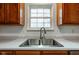 Close-up of the kitchen sink with stainless steel dual basin and stainless steel faucet, with window and cabinetry at 20107 Marie Ct, Noblesville, IN 46062
