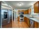 Open concept kitchen featuring stainless steel appliances, wood cabinets, and access to other living spaces at 20107 Marie Ct, Noblesville, IN 46062