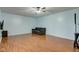 Expansive living room with hardwood floors, ceiling fan, and light blue walls, filled with natural light at 20107 Marie Ct, Noblesville, IN 46062