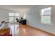 Bright living room with laminate floors and windows providing natural light, featuring a desk setup at 20107 Marie Ct, Noblesville, IN 46062