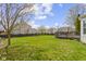 Large backyard with green grass and a wooden deck, perfect for outdoor entertaining at 203 Winslow Dr, Westfield, IN 46074