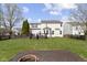 A spacious backyard featuring a wooden deck, lush green grass, and privacy fence at 203 Winslow Dr, Westfield, IN 46074