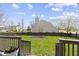 Scenic backyard view featuring a fire pit, green lawn, and secure fencing at 203 Winslow Dr, Westfield, IN 46074