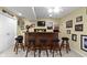 A well-lit basement bar featuring a wooden bar, stools, decorations and a TV at 203 Winslow Dr, Westfield, IN 46074
