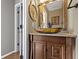 Bathroom featuring a decorative bowl sink, a wood framed mirror, and custom cabinets at 203 Winslow Dr, Westfield, IN 46074