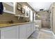 Bathroom featuring double sinks with granite countertops, white cabinets, and a glass-enclosed shower at 203 Winslow Dr, Westfield, IN 46074