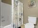 A functional bathroom featuring a toilet, shower, and themed shower curtain for privacy at 203 Winslow Dr, Westfield, IN 46074