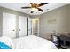 A peaceful bedroom featuring a cozy bed, multiple doors, and a desk for work or study at 203 Winslow Dr, Westfield, IN 46074