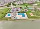 An aerial view of the community pool, tennis courts, sand volleyball court, and playground with lake views at 203 Winslow Dr, Westfield, IN 46074