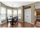 The dining area features hardwood floors, bright windows, and a modern chandelier at 203 Winslow Dr, Westfield, IN 46074