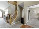 Inviting foyer featuring a staircase with wooden banister and an open floor plan leading to the kitchen and living areas at 203 Winslow Dr, Westfield, IN 46074