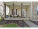 Inviting front porch with seating area, decorative plants, and welcome sign at 203 Winslow Dr, Westfield, IN 46074