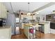 Kitchen with stainless appliances, an island, a breakfast bar, and seamless access to the living room at 203 Winslow Dr, Westfield, IN 46074