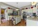 Kitchen features neutral cabinets, stainless steel appliances, an island, and granite countertops at 203 Winslow Dr, Westfield, IN 46074