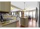 Open kitchen with island, breakfast bar seating, granite countertops, and stainless steel dishwasher at 203 Winslow Dr, Westfield, IN 46074