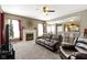 Inviting living room with fireplace, neutral colors, a ceiling fan, and seamless access to the kitchen at 203 Winslow Dr, Westfield, IN 46074