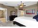 Bright main bedroom showcasing a ceiling fan, dresser with mirror, and doorway leading to a bath at 203 Winslow Dr, Westfield, IN 46074