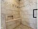 Close-up of a custom tiled shower with built-in bench and mosaic accents at 203 Winslow Dr, Westfield, IN 46074
