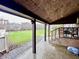 Covered back porch overlooking a spacious backyard, perfect for outdoor relaxation at 204 W Berry St, Alexandria, IN 46001