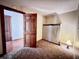 Compact bedroom with carpet flooring and a classic wooden door at 204 W Berry St, Alexandria, IN 46001
