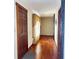 Hallway featuring hardwood floors, natural light, and classic wooden door frames at 204 W Berry St, Alexandria, IN 46001