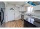 Bright kitchen featuring stainless steel appliances, white cabinets, a modern sink, and wood-look flooring at 2134 Dawson St, Indianapolis, IN 46203
