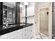 Modern bathroom featuring double vanity with dark countertop and mosaic tile accents at 2349 N Delaware St, Indianapolis, IN 46205
