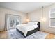 Serene bedroom features a black storage bed frame, light fixtures, and French doors to a balcony at 2349 N Delaware St, Indianapolis, IN 46205
