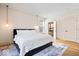 Spacious bedroom with storage bed, light fixture, and view of a bathroom at 2349 N Delaware St, Indianapolis, IN 46205