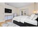 Well-lit bedroom features a dresser, storage bed frame, and French doors to a balcony at 2349 N Delaware St, Indianapolis, IN 46205