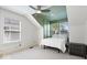 Bright bedroom with white bedding, ceiling fan, and plenty of natural light at 2349 N Delaware St, Indianapolis, IN 46205