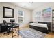 Bright bedroom with a work space, daybed, and large window overlooking trees at 2349 N Delaware St, Indianapolis, IN 46205