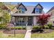 Charming home featuring a covered porch, well-manicured landscaping, and a welcoming facade at 2349 N Delaware St, Indianapolis, IN 46205