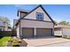 Three car garage with neutral colored siding and manicured landscaping at 2349 N Delaware St, Indianapolis, IN 46205
