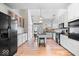 Modern kitchen with white cabinets, stainless steel appliances, and an island with barstool seating at 2349 N Delaware St, Indianapolis, IN 46205