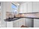 Kitchen area showcases stone backsplash, stainless appliances, black countertop, and a stainless steel sink at 2349 N Delaware St, Indianapolis, IN 46205