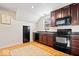 Cozy kitchenette with wooden cabinets, a black fridge, stove, and microwave, perfect for simple cooking at 2349 N Delaware St, Indianapolis, IN 46205