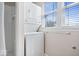 Convenient laundry area featuring a stacked washer and dryer and a window for natural light at 2349 N Delaware St, Indianapolis, IN 46205