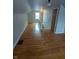 An attic space with hardwood floors, a small window, and stairs leading to another area at , Indianapolis, IN 46220