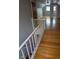Upper hallway featuring hardwood floors, access to several rooms, and stairs to other floors at , Indianapolis, IN 46220