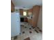Traditional kitchen boasts wood cabinets, contrasting tiled floors, and modern black appliances at , Indianapolis, IN 46220