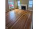 Bright living room with hardwood floors, a fireplace, and natural light from large windows at , Indianapolis, IN 46220