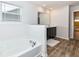 A bathroom featuring a soaking tub and a double vanity for optimal convenience at 286 Lar Lan Dr, Danville, IN 46122