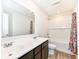 Bathroom features a double sink vanity, shower-tub combo, and decorative shower curtain at 286 Lar Lan Dr, Danville, IN 46122