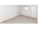Neutral bedroom featuring plush carpet, white walls, and a window at 286 Lar Lan Dr, Danville, IN 46122