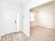 Inviting entryway with wood-look floors and a view into a carpeted room with a window at 286 Lar Lan Dr, Danville, IN 46122