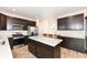 Bright kitchen features stainless steel appliances, dark cabinets and a center island with sleek white countertops at 286 Lar Lan Dr, Danville, IN 46122